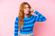 © luismolinero - Young caucasian woman isolated on pink background making the gesture of madness putting finger on the head