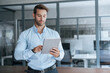 © Stock 4 You - Focused young European entrepreneur businessman looking at digital tablet screen in office. Latin hispanic man male manager in working using computer for financial business banking work. Copy space