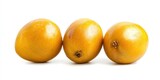 Three golden kaki fruits are arranged in a row on a white surface. The fruits have a smooth, glossy texture and a warm, amber color