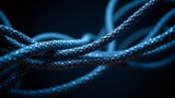 Blue braided cord - Abstract pattern of intertwined rope on dark surface.