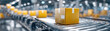 © Monthon - Food delivery online order concept with yellow parcel box on conveyor belt in warehouse for fast shipping service