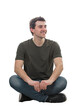 © 1STunningART - Cheerful young man seated relaxed, with crossed legs, on the floor, looking away smiling isolated on transparent background