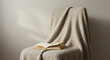 © NATALIA - Cozy chair with soft blanket and open book in warm lighting