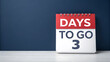 © rafe - A red and white flip calendar prominently displays the number three with the words days to go indicating a countdown to an important event or deadline