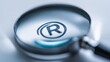 © Iryna - Magnifying glass focusing on a registered trademark symbol, highlighting brand protection in intellectual property