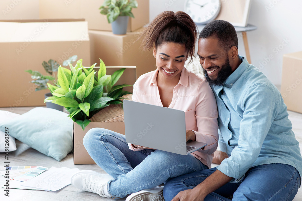Foto Smiling millennial african american wife showing to husband laptop ...