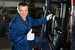 © JackF - Experienced forklift driver transporting iron sheets inside a metallurgical plant