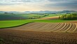 © Ева Торяник - Beautiful Countryside Landscape With Ploughed Fields And Hills: Polish Agricultural Charm In Spring With Lush Green Meadows And Farmland In Ponidzie Region.