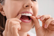 © Pixel-Shot - Young woman putting occlusal splint in mouth at home, closeup