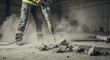 © SaifulAziz - Concrete Demolition with Jackhammer in Dusty Industrial Setting