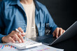 © Kiattisak - Invoice bill and digital accounting concept. Businessman using calculator and laptop with invoice online billing system, tax calculation, and financial documentation.