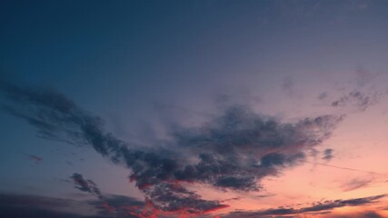 Wall Mural - A sunrise sky timelapse with fiery orange and purple clouds conveys the concept of awakening. It also reflects renewal, resilience, transformation, and the natural rhythm guiding each new beginning.
