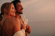 © Jacob Lund - Young couple enjoying serene sunset with glasses of wine, embracing peaceful moments
