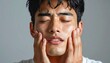 © NafiliaEmil - Young asian man isolated on gray background touching his face and closing eyes with expression of horrible suffer from health problem and aching tooth. Detailed high quality image.