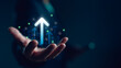 © Looker_Studio - Businessman hand holding virtual glowing arrow up icon, representing business growth, financial performance, investment success and positive economic trend with percentage symbols.