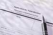 © Tetra Images - Close-up of pen on application for citizenship