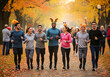 © Peeradontax - A happy and diverse group of young adults participates in a Turkey Trot, a fun run traditionally held on Thanksgiving.