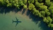 © Fahroni - Commercial passenger aircraft shadow crossing pristine tropical mangrove forest ecosystem showcasing sustainable aviation fuel innovation for environmentally responsible air travel business concept.