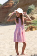© Tatiana Foxy - Full-Length Girl Holding Sun Hat Looking Sideways