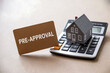 © ريحان - Miniature house on calculator with pre approval card home finance