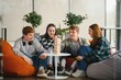 © Serhii - Friends playing engaging board game, having fun together