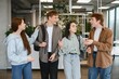 © Serhii - Happy students walking and talking in university hallway