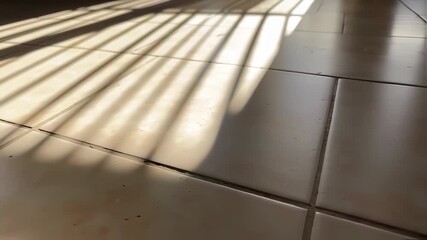 Dynamic play of light and shadow across floor tiles, creating pattern formations