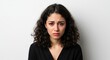 © Hungarian - A woman with teary eyes portrays sadness against a plain background.