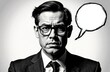 © starush - A serious man wearing glasses and a suit with a blank speech bubble in a black-and-white portrait