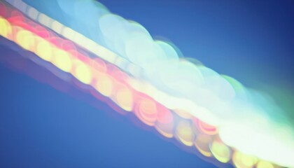 Wall Mural - soft glowing bokeh of colorful city lights on deep blue background creating dreamy abstract texture for wallpaper or banner
