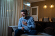 © Nenad - Mature man experiencing sudden chest pain at home, sitting in living room in evening, heart attack, emergency, health concept