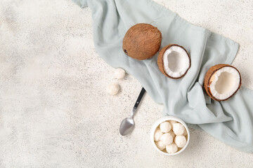 Wall Mural - Coconuts and bowl with white chocolate candies on light table