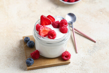 Wall Mural - Jar of tasty yogurt with different fresh berries on white background