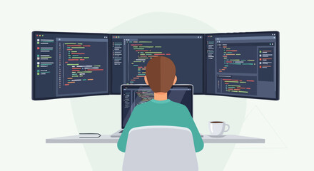 A software developer or programmer writing code on multiple computer monitors in a home office.