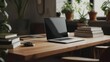 © and - Laptop on wooden desk among books and plants