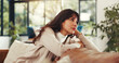 © peopleimages.com - Woman, rest and thinking on couch in home for reflection, nostalgia and memory in living room. Person, tired and break on sofa with insight, inspiration or perspective for decision at apartment