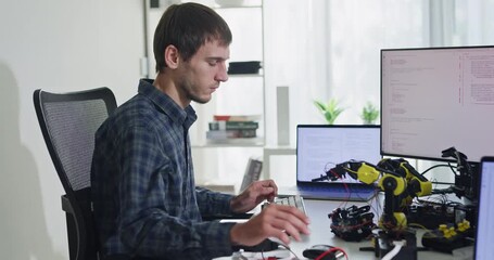 Team of male developers work code control robotics system and software automation project write prompt AI data bot at office. Artificial intelligence, collaboration, robotic, debugging, machine learn.