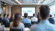 © Rachel - Blurry image of business presentation with audience seated in modern conference room, focusing on learning and collaboration