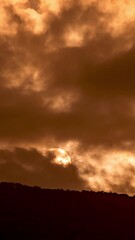 Wall Mural - Timelapse of dramatic sunrise with orange sky in a cloudy day.
