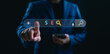 © Looker_Studio - Businessman using AI-powered SEO search engine optimization tool on virtual interface, representing digital marketing strategy, website ranking, and online visibility.