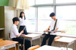© apiox - 文化祭に向けてバンド練習をする生徒たち　学校の教室での青春イメージ