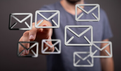 Close-up of a person interacting with email icons on a digital interface.