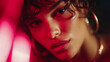 © Aliaksandra - Close-up portrait of a woman with curly hair, glowing skin, and red light shadows creating an artistic dramatic effect