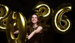 © ty - Happy gorgeous girl in stylish sexy party dress holding gold 2026 balloons, having fun at New Year's Eve Party.