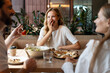 © Maria Vitkovska - Friends laughing and eating pizza together at restaurant