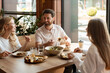 © Maria Vitkovska - Family enjoying lunch together at a restaurant