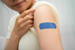 © kanruthai - HPV, Human papillomavirus, Asian young woman receiving vaccine with blue bandage.