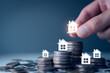 © LALAKA - Real estate property investment concept, stacking coins and model house increasing, invest real estate property, house, apartment, office, property tax and Inflation Insurance