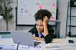 © Parichat - Stressed african american businesswoman looking at laptop with concerned expression in office