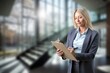 © BillionPhotos.com - Smiling business woman entrepreneur standing in office